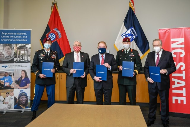 The 82nd Airborne Div. formalized its relationship with the University of North Carolina System with the signing of an Educational Partnership Agreement along with the XVIII Airborne Corps in a small ceremony Jan. 28, on the campus of NC State University. From left to right in the photograph is Cpt. David A. Giralt, innovation officer, Dr. Randy Woodson, chancellor NC State University, Mr. Peter Hans, president of the University North Carolina System, Canadian Brig. Gen. Robert T. Ritchie, assistant commanding general operations XVIII Airborne Corps, Dr. Mladen Vouk, vice chancellor NC State research and innovation. 