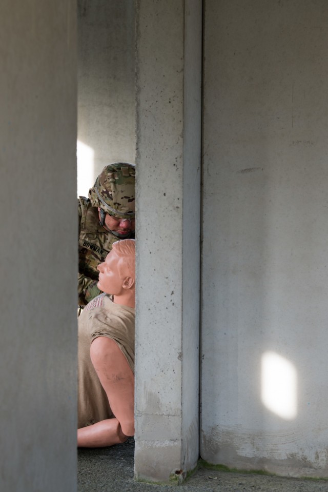 U.S. Army Staff Sgt. Devon Bowman, a U.S. Army Garrison Benelux MP assigned in Brussels, Belgium, treats a simulated casualty as he competes in the medical lane of the Best Warrior Competition, on Chièvres Air Base, Belgium, Jan. 26, 2021. (U.S....