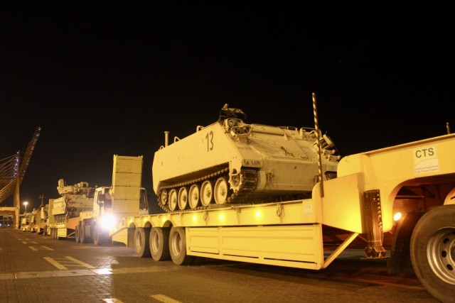 A 2nd Armored Brigade Combat Team, 1st Armored Division, M1068 command post vehicle sits atop a lowboy in queue to board the Green Ridge at the Port of Shuaiba, Kuwait, Jan. 22, 2021. The equipment, bound for the United Arab Emirates, will be received by 2/1 ABCT Soldiers and is scheduled to be utilized during exercise Iron Union 14. (U.S. Army photo by Claudia LaMantia)