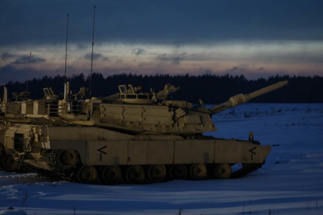 Abrams Tanks are parked in a line on a range before a nighttime section gunnery at the Pabrade Training Area, Lithuania, on Jan. 22, 2021. The tank crews, along with Bradley Fighting Vehicle and mortar sections, completed the gunnery to test the...