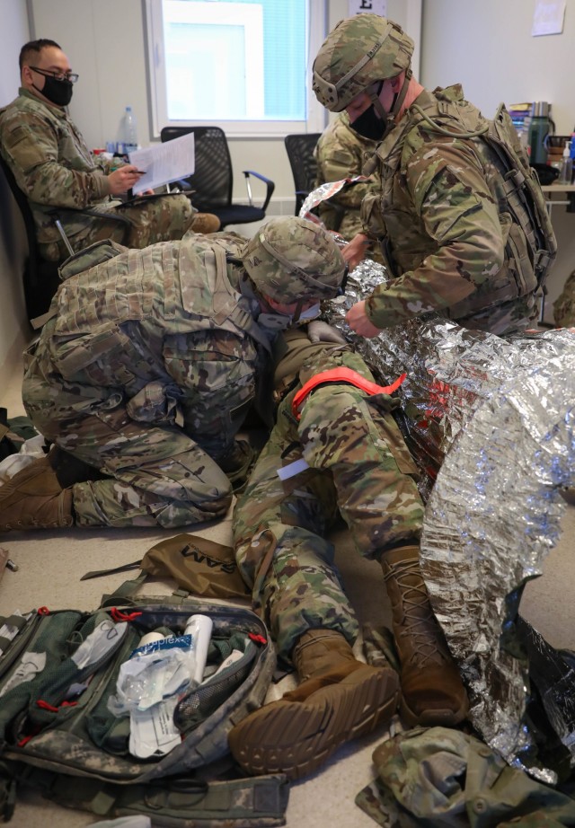 Combat medic specialists assigned to 2nd Battalion, 8th Cavalry Regiment, treat a simulated battlefield casualty during a Jan. 30, 2021, Tactical Combat Casualty Care assessment at the Pabrade Training Area, Lithuania. Participating in the...