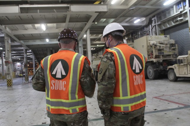 Capt. Christopher Lang, 1185th Deployment and Distribution Support Battalion, and Maj. Gregory Gemedschiew, 1185th DDSB, discuss the loading plan for 2nd Armored Brigade Combat Team, 1st Armored Division, equipment aboard the Green Ridge at the Port of Shuaiba, Kuwait, Jan. 22, 2021. The equipment, bound for the United Arab Emirates, will be received by 2/1 ABCT Soldiers and is scheduled to be utilized during exercise Iron Union 14. (U.S. Army photo by Claudia LaMantia)