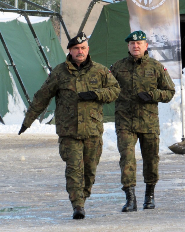 Special guest General Jaroslaw Mika, head of Polish Armed Forces, strides onto the parade field with one of his commanders during a NATO enhanced Forward Presence Battle Group Poland Change of Command Ceremony Jan.28, 2021, at Bemowo Piskie Training Area, Poland. (Photo courtesy of eFP BGP PAO)