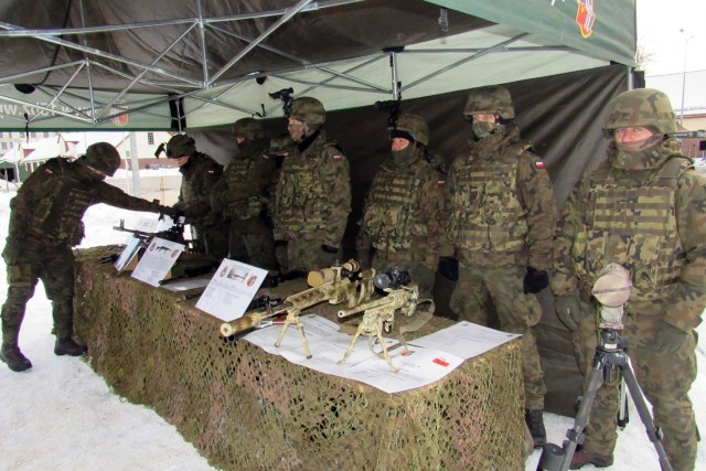 Polish Army Troops from the 15th Mechanized Brigade, 16th Division, stand by a static display they created for the NATO enhanced Forward Presence Battle Group Poland Change of Command Ceremony Jan.28, 2021, at Bemowo Piskie Training Area, Poland. (Photo courtesy of eFP BGP PAO)