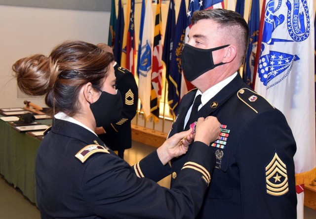 Col. Lynn Marm, left, pins the Legion of Merit medal on to Sgt. Maj. Corey A. Lord, whose 30-year career was recognized during a retirement ceremony on Jan. 29 at Fort Detrick, Maryland.