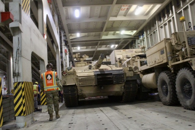 Capt. Christopher Lang, 1185th Deployment and Distribution Support Battalion, inspects the loading process aboard the Green Ridge at the Port of Shuaiba, Kuwait, Jan. 22, 2021. The equipment, bound for the United Arab Emirates, will be received by 2/1 ABCT Soldiers and is scheduled to be utilized during exercise Iron Union 14. (U.S. Army photo by Claudia LaMantia)