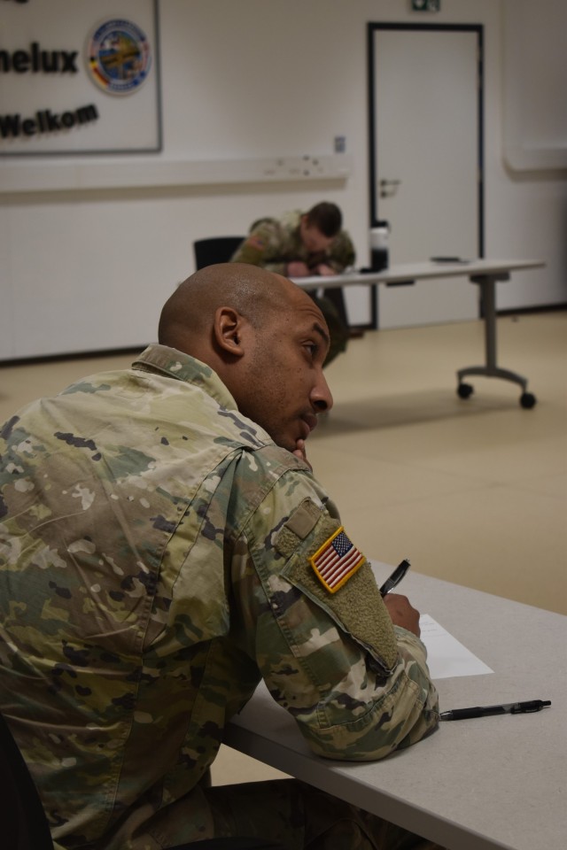 CHIÈVRES, Belgium – Spc. Adonis Singletary, an investigator with DES at the Brussels Site, takes a written portion of the U.S. Army Garrison Benelux Best Warrior Competition Jan. 25. After a week competing against their garrison peers, two U.S....