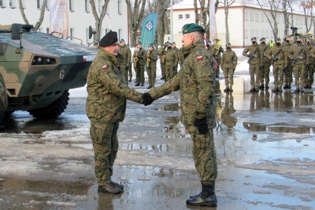 Special guest General Jaroslaw Mika, head of Polish Armed Forces, shakes the hand of one of his commanders during the enhanced Forward Presence Battle Group Poland change of command ceremony Jan. 28, 2021, at Bemowo Piskie Training Area, Poland. (Photo courtesy eFP BGP PAO)