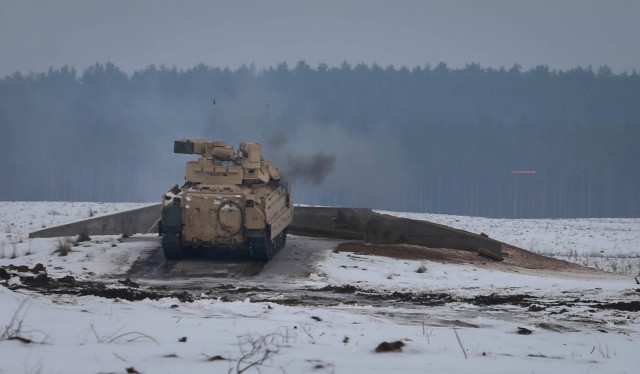 A Bradley Fighting Vehicle crew fires the main gun during a Jan. 22, 2021, section gunnery at the Pabrade Training Area, Lithuania. The 2nd Battalion, 8th Cavalry Regiment section gunnery tested the skills of the sections and demonstrated...