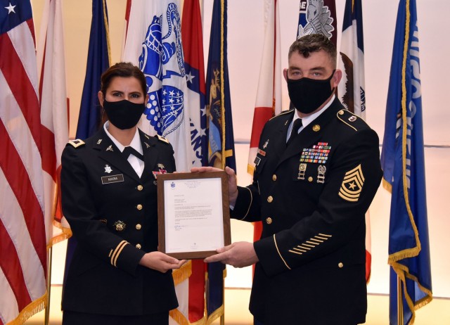 Col. Lynn Marm, left, presents Sgt. Maj. Corey A. Lord with his certificate of retirement from the U.S. Army during his retirement ceremony on Jan. 29 at Fort Detrick, Maryland.