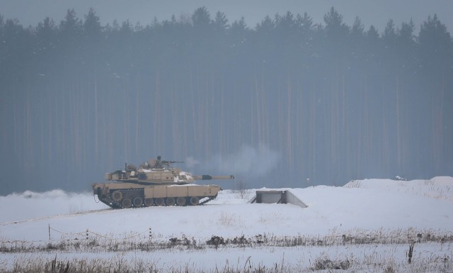 A Trooper assigned to 2nd Battalion, 8th Cavalry Regiment fires a .50-caliber machine gun from the top of a Bradley Fighting Vehicle during a gunnery Jan. 22, 2021, at the Pabrade Training Area, Lithuania. The gunnery tested the skills and...