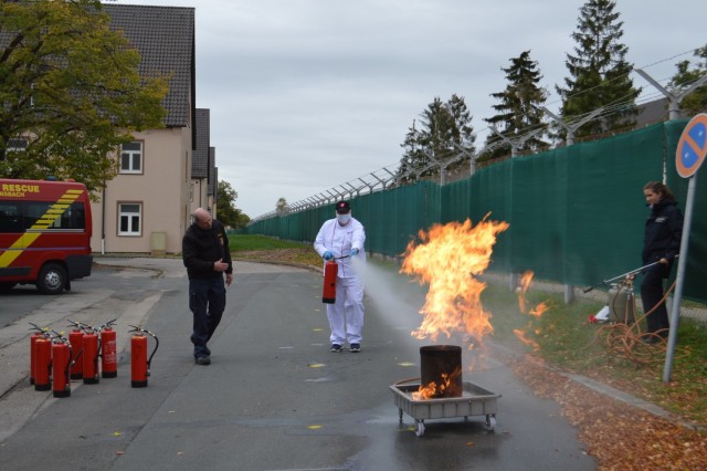 A U.S. Army Garrison Ansbach firefighter instructor teaches the Katterbach Dining Facility members how to put out a fire with a fire extinguisher Oct. 6, 2020.  U.S. Army Garrison Ansbach Directorate of Emergency Services firefighters who were...