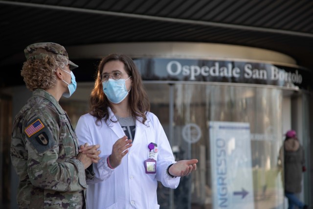 Lt. Col. Kelley C. Togiola, left, public health emergency officer, and
Pietro Maculan, resident at the San Bartolo hospital, chat during a personal protective equipment (PPE) delivery at San Bortolo Hospital, Vicenza, Italy, Feb. 1, 2021. The U.S. Army Garrison Italy assisted in delivering $500,000 worth of PPE to Italian hospitals in Vicenza, Pisa and Livorno. (U.S. Army Spc. Meleesa Gutierrez)