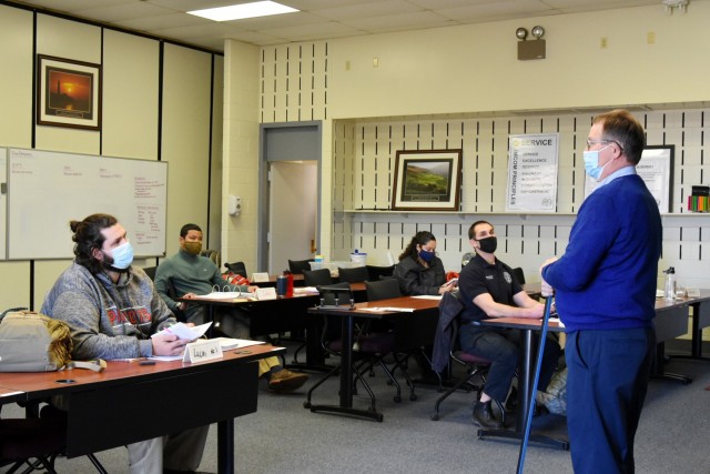 Kenneth Fortune (right), Forging New Leader program instructor, answers questions during the last day of class covering Army Design Methodology and Military Decision Making Progress instruction.