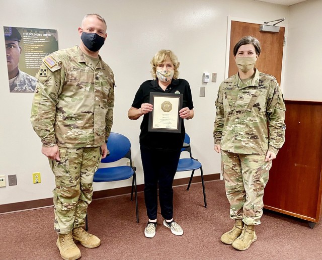 Command Sgt. Maj. Alexander Poutou, Bayne-Jones Army Community Hospital command sergeant major (left), Sherlynn White (center) and Col. Jody Dugai (right), BJACH commander, pose for a photo after  White’s 45-year certificate and pin presentation...