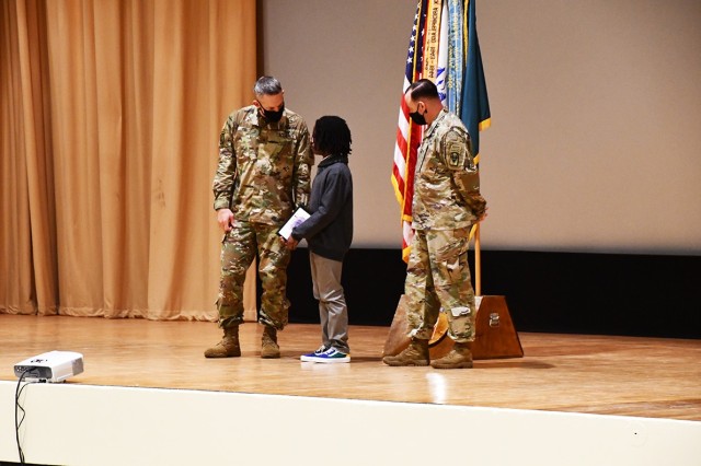 From left to right: Brig. Gen. David S. Doyle, Joint Readiness Training Center and Fort Polk commanding general, thanks Josias Blount, 13, as Command Sgt. Maj. Michael C. Henry, post command sergeant major, looks on at the Fort Polk Volunteer of...