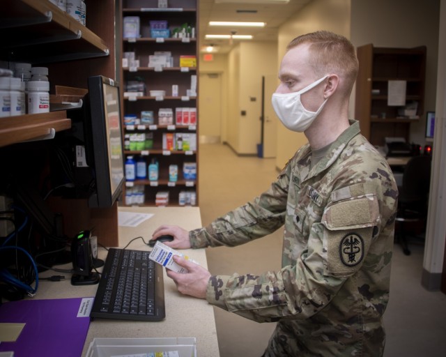 Army Spc. Trevor Osburn, pharmacy technician, fills prescriptions at the Community Pharmacy in the Exchange, Fort Sam Houston, Texas, Feb. 1, 2021. The Community Pharmacy fills an average of 330 new prescriptions and 1,440 refills daily. (U.S. Army photo by Jason W. Edwards)