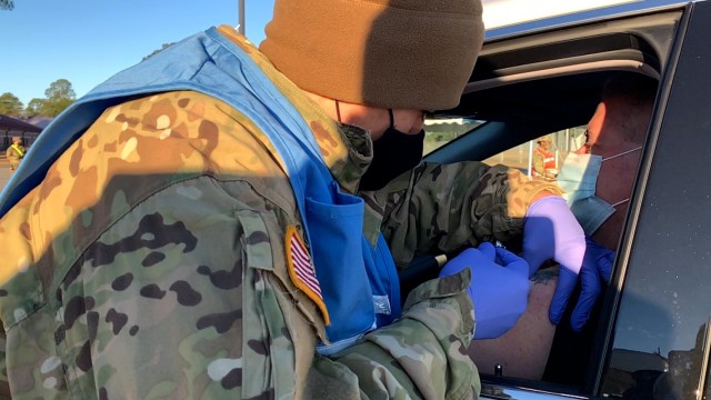A Winn Army Community Hospital staff member helps at the Installation test run of the COVID-19 Vaccination Clinic on Fort Stewart, Jan. 29. Winn ACH, in coordination with the 3rd Infantry Division, conducted a COVID-19 drive-through vaccination...