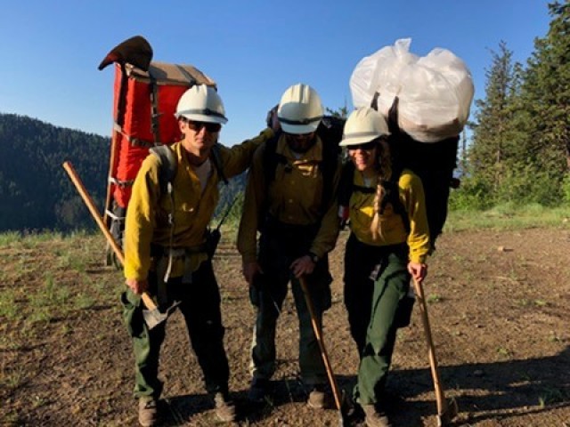 Tessa Morris shows she can carry her share of the weight during a rookie rappeller pack out, part of a grueling certification process with demanding physical fitness standards.