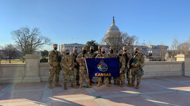 Kansas National Guardsmen pose with the Kansas flag in front of the U.S. Capitol in Washington, D.C. Jan 24. More than 250 Kansas National Guard Soldiers and Airmen travelled to D.C. Jan. 17 to provide security in support of the presidential...