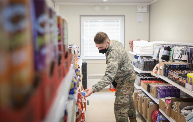 Pfc. John Mabile, a mortarmen assigned to 2nd Battalion, 8th Cavalry Regiment, picks up a tuna snack kit at the Mobile Field Exchange that opened Feb. 1, 2021, at the Pabrade Training Area, Lithuania. Mabile was the first Trooper to shop in the first Exchange facility established in the Baltic States. (Photo by U.S. Army Sgt. Alexandra Shea)