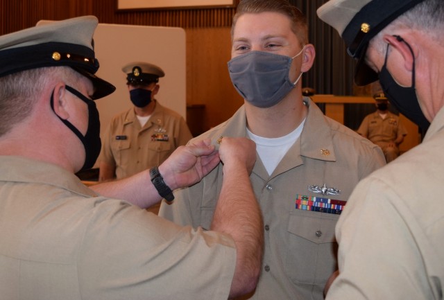 A mask can’t hide the smile of Dylan Munn as fellow Sailor pin on his golden anchors signifying his promotion to chief petty officer on Jan. 29, 2021, at White Sands Missile Range, N.M.