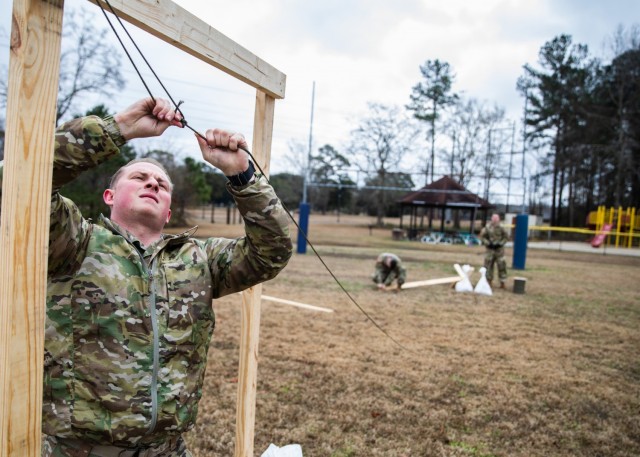 Capt. Colin Kanzari, the 3rd Brigade Combat Team, 82nd Airborne Division air operations officer, builds mock doors at Joint Base Charleston, S.C., February 1, 2021. The mock doors allow Paratroopers to practice exiting an aircraft during Sustained Airborne Training.