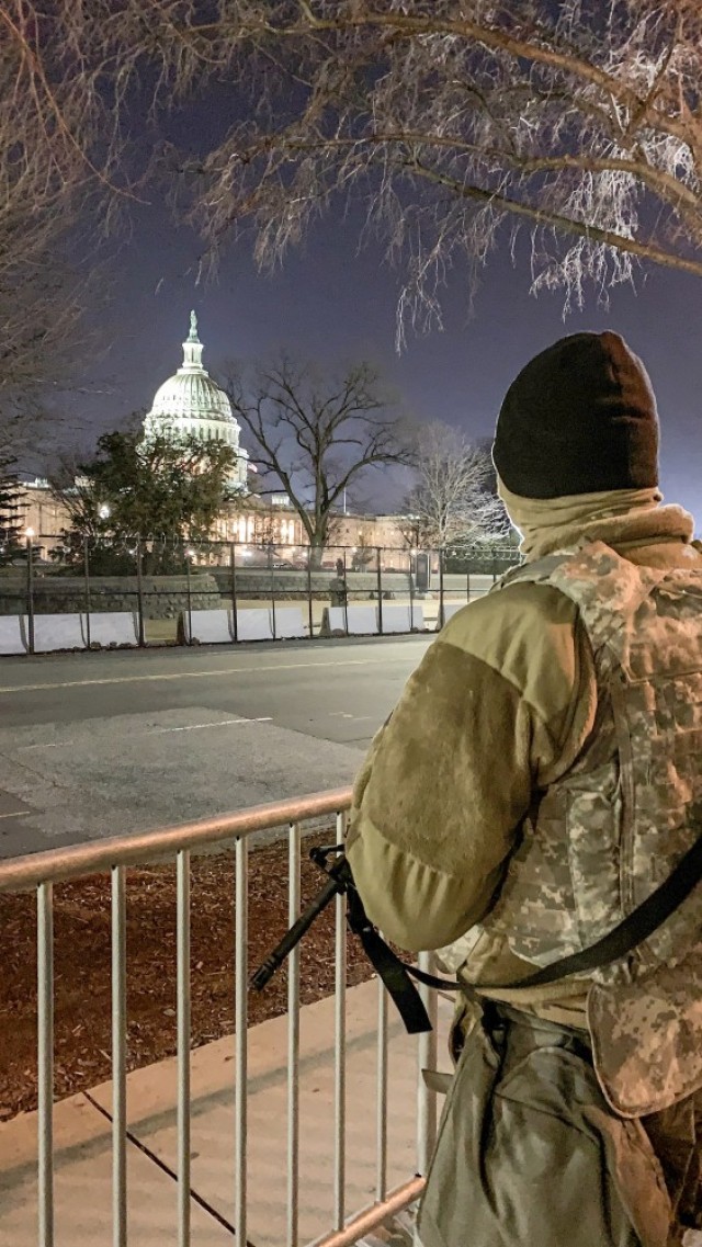 A Kansas National Guardsman stands watch in Washington D.C. with a view of the U.S. capitol building. More than 250 Kansas National Guard Soldiers and Airmen travelled to D.C. Jan. 17 to provide security in support of the presidential...