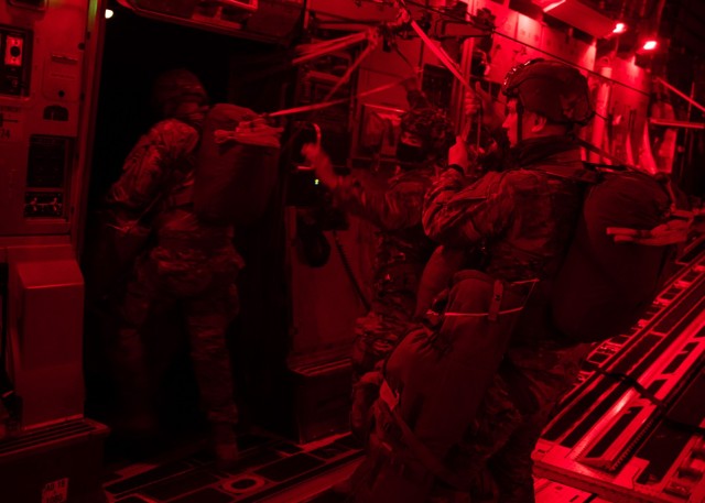 Paratroopers exit a U.S. Air Force C-17 Globemaster III over Geronimo Drop Zone at Fort Polk, Louisiana, February 1, 2021.
