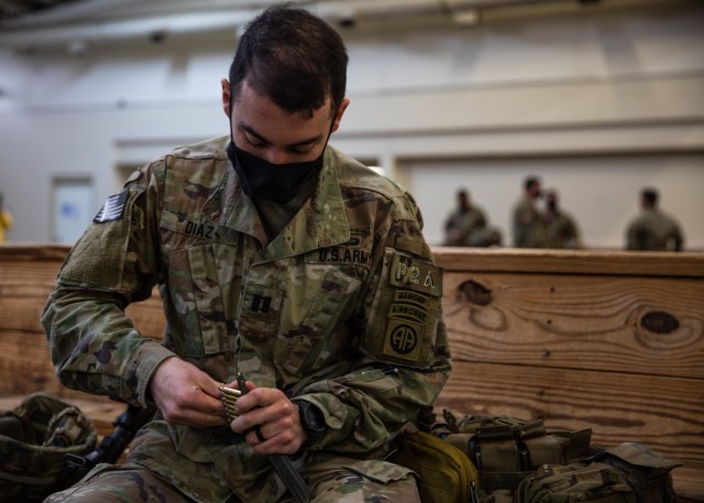 An officer assigned to 3rd Brigade Combat Team, 82nd Airborne Division loads his magazine with blank ammunition on Fort Bragg, N.C., January 31, 2021. This ammunition will be utilized during the brigade&#39;s upcoming Joint Readiness Training Center rotation.