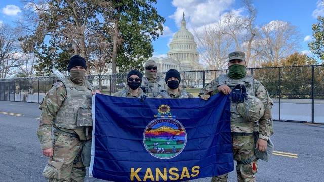 Kansas National Guardsmen pose with the Kansas flag in front of the U.S. Capitol in Washington, D.C. Jan 24. More than 250 Kansas National Guard Soldiers and Airmen travelled to D.C. Jan. 17 to provide security in support of the presidential...