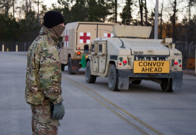 A Paratrooper assigned to 1st Battalion, 508th Parachute Infantry Regiment, 3rd Brigade Combat Team, 82nd Airborne Division guides vehicles through Fort Bragg, N.C. during a Deployment Readiness Exercise, January 28, 2021. (Photo by Sgt. John Lytle, 3rd BCT PAO) 