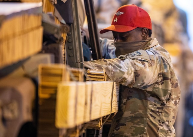 Sgt. Givauni Armstrong, a parachute rigger assigned to 151st Quartermaster Company, 189th Combat Sustainment Support Battalion, 82nd Airborne Division Sustainment Brigade, prepares a vehicle for heavy drop at Joint Base Charleston, S.C., January 21, 2021. The heavy drop platforms were being prepared for an upcoming Joint Readiness Training Center rotation.
