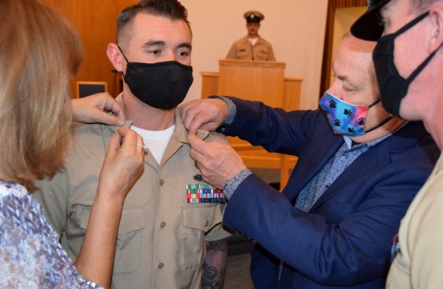 Proud parents pin golden anchors onto the collar of Shawn Cavasos during his promotion ceremony to chief petty officer held Jan. 29, 2021, at White Sands Missile Range, N.M.