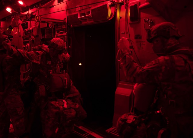 A Jumpmaster assigned to 3rd Brigade Combat Team, 82nd Airborne Division gives the &#34;30-Second&#34; warning to Paratroopers aboard a U.S. Air Force C-17 Globemaster III bound for Fort Polk, Louisiana, February 1, 2021.