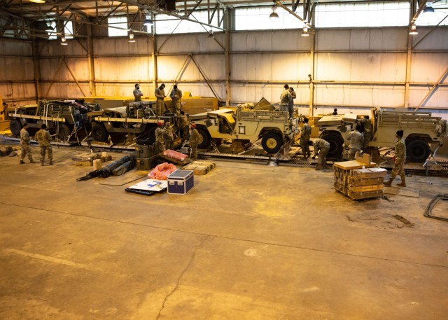 Paratroopers from 2nd Brigade Combat Team and riggers from the 82nd Airborne Division Sustainment Brigade prepare vehicles for heavy drop at Joint Base Charleston, S.C., January 21, 2021. The heavy drop platforms were being prepared for an upcoming Joint Readiness Training Center rotation.