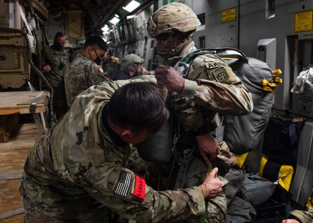 A Paratrooper assigned to 3rd Brigade Combat Team, 82nd Airborne Division gets inspected by a Jumpmaster on a U.S. Air Force C-17 Globemaster III bound for Fort Polk, Louisiana, February 1, 2021.