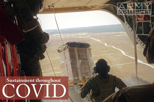 Spc. Tashara Williams pushes a bundle of Class I with Low Cost Low Altitude parachutes over All-American Drop Zone March 14, 2020, at Fort Bragg, N.C.