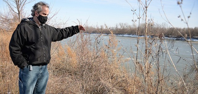 Tom Dow, Directorate of Public Works master planner, looks out over the Missouri River as he explains how floods have badly eroded the bank Jan. 29 by Sherman Army Airfield. The area around the airfield is currently undergoing work to repair flood...