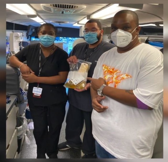 Orlando Davis, radio personality at WiLD 94.1 radio station, gathers for a photo with OneBlood team members in Tampa, Florida, after making a plasma donation in November. (Photo courtesy of Maj. Katherine Williams, ASC).