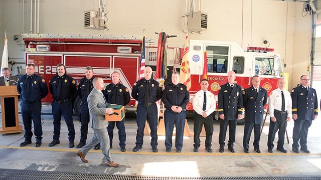 Awards bearer Josh Altice, Workforce Development Program specialist, walks in front of assembled Fort Leavenworth Fire Department leaders — including ...