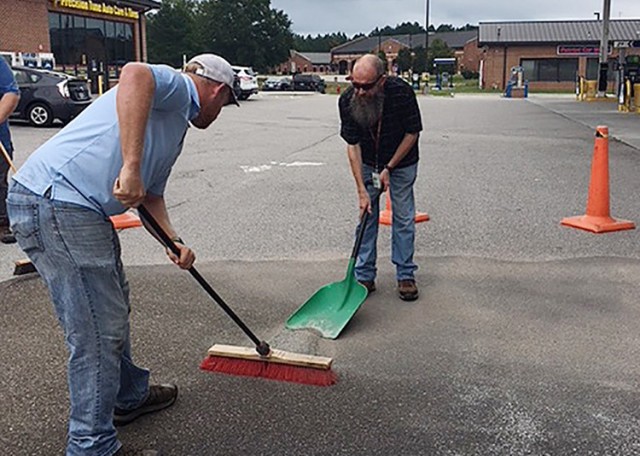 Fort Lee Fire Department and DPW Environmental Management Division personnel clean up a fuel spill that recently occurred at the AAFES gas station as a result of a patron walking away while his vehicle was being filled with gas. The pump handle...