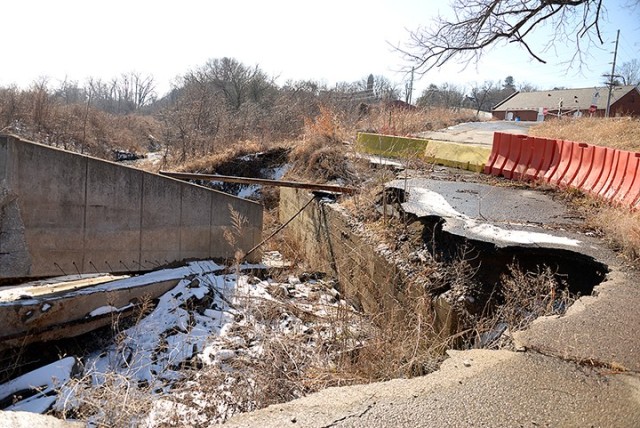 A washed-out road and fallen flood-protection wall near the closed south railroad crossing, seen here Jan. 29, are some of the issues being addressed in ongoing flood repairs being made around Sherman Army Airfield. The levee road around the...