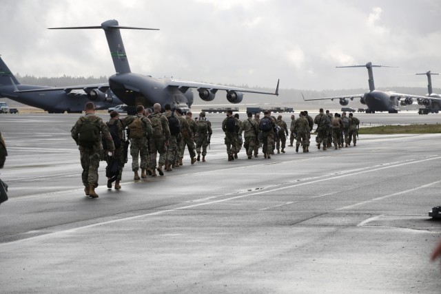Washington National Guard members leave the McChord Field passenger terminal and walk to an awaiting KC-135 to head to D.C. to support Operation Capitol Response Jan. 15, 2021, at Joint Base Lewis-McChord, Wash. The 141st Air Refueling Wing flew...