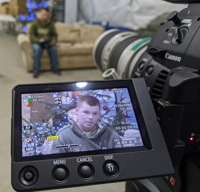 A U.S. Army Soldier from 2d Squadron, 2d Cavalry Regiment, enhanced Forward Presence Battle Group Poland, is captured in the viewfinder of a video camera as he is recorded reading a story for his children December 2020, at Bemowo Piskie Training Area, Poland.  (U.S. Army photo by Staff Sgt. Chad Guthrie)