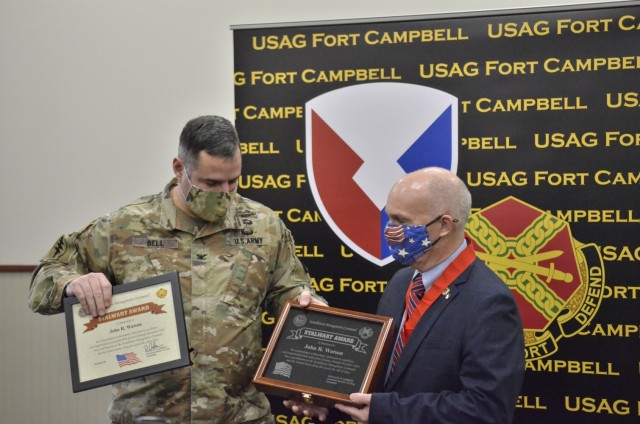 John Watson, chief of Fort Campbell’s Training Division, Directorate of Plans, Training, Mobilization and Security, receives an Installation Management Command Stalwart Award from Col. Jeremy D. Bell, Fort Campbell garrison commander, during a virtual Installation Management Command awards presentation Jan. 28 at Eagle Conference Room.