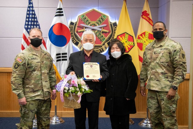 CAMP HUMPHREYS, Republic of Korea - Col. Michael F. Tremblay, left, the commander of United States Army Garrison Humphreys, and Command Sgt. Maj. Benjamin Lemon, the senior enlisted advisor for USAG-Humphreys, right, present the Good Neighbor...