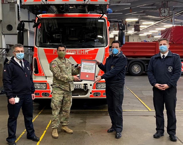 WIESBADEN, Germany – U.S. Army Garrison Wiesbaden Director of Emergency Services Lt. Col. Edwin Escobar (second to left) and acting city of Wiesbaden Fire Chief Johannes Mumbauer (second to right) hold the certificate of appreciation that was...