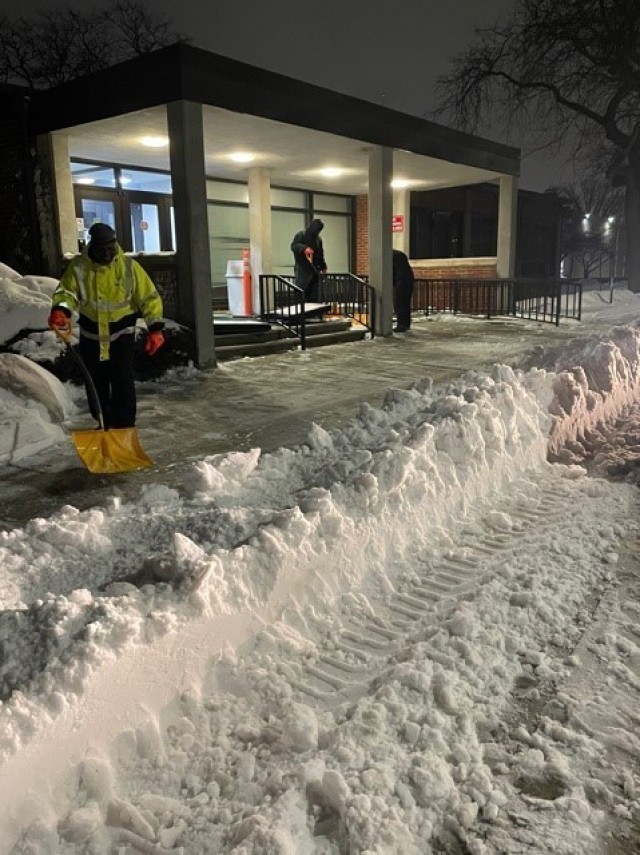 Base operations contractors shovel snow and clear paths before the sun rises on Fort Hamilton, N.Y., Feb. 2, 2021. A major winter storm struck the Mid-Atlantic and Northeast, creating near-blizzard conditions along the coast, forcing many to stay...