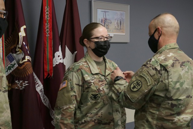 Brig. Gen. Jack M. Davis, commanding general of Regional Health Command-Pacific and chief of the Army Nurse Corps, pins the meritorious service medal on the uniform of Sgt. 1st Class Jackie Lord during a ceremony at Madigan Army Medical Center on Joint Base Lewis-McChord, Wash., where a video call with the acting secretary of the Army John E. Whitley was joined for the announcement on February 4 that Lord is the active duty Career Counselor of the Year.